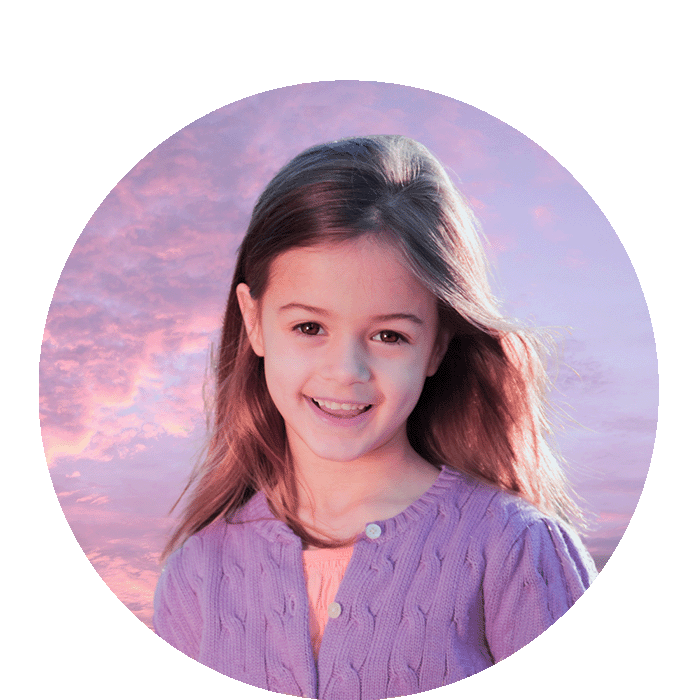 A little girl with a  pink sunset background